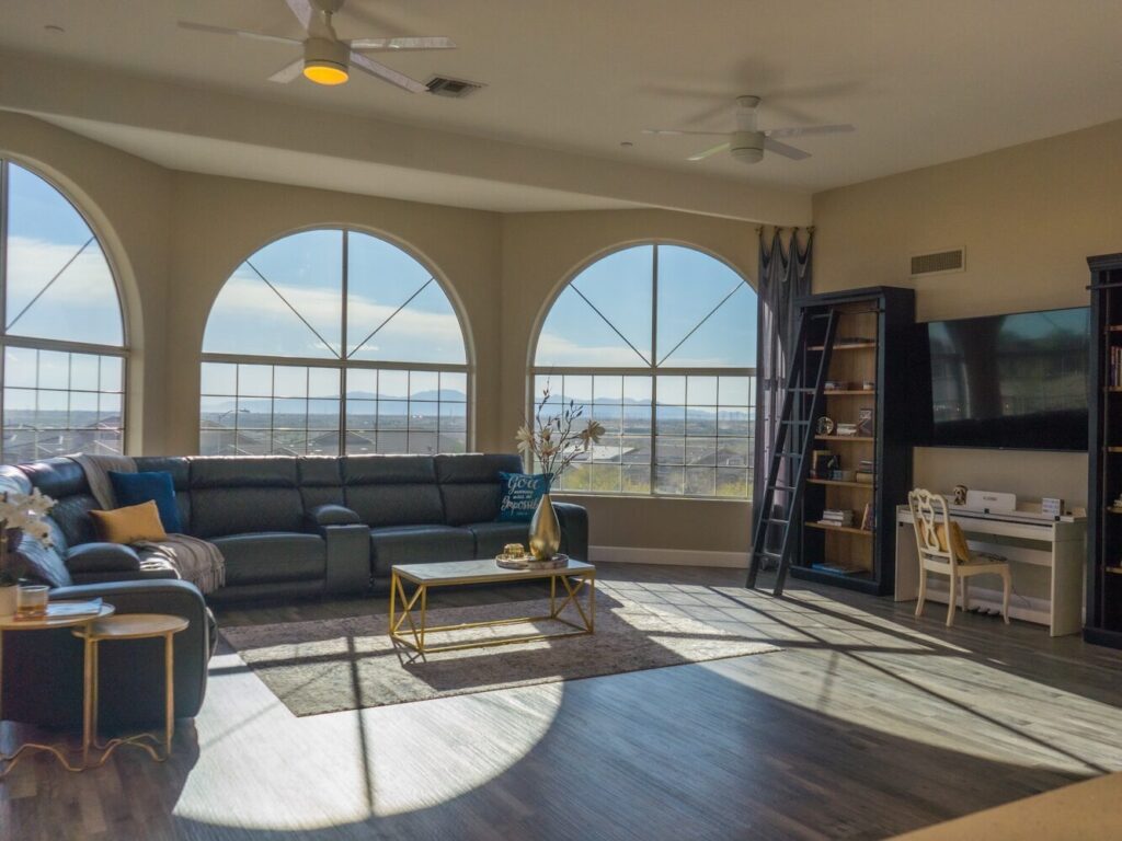 living room filled with furniture and large windows