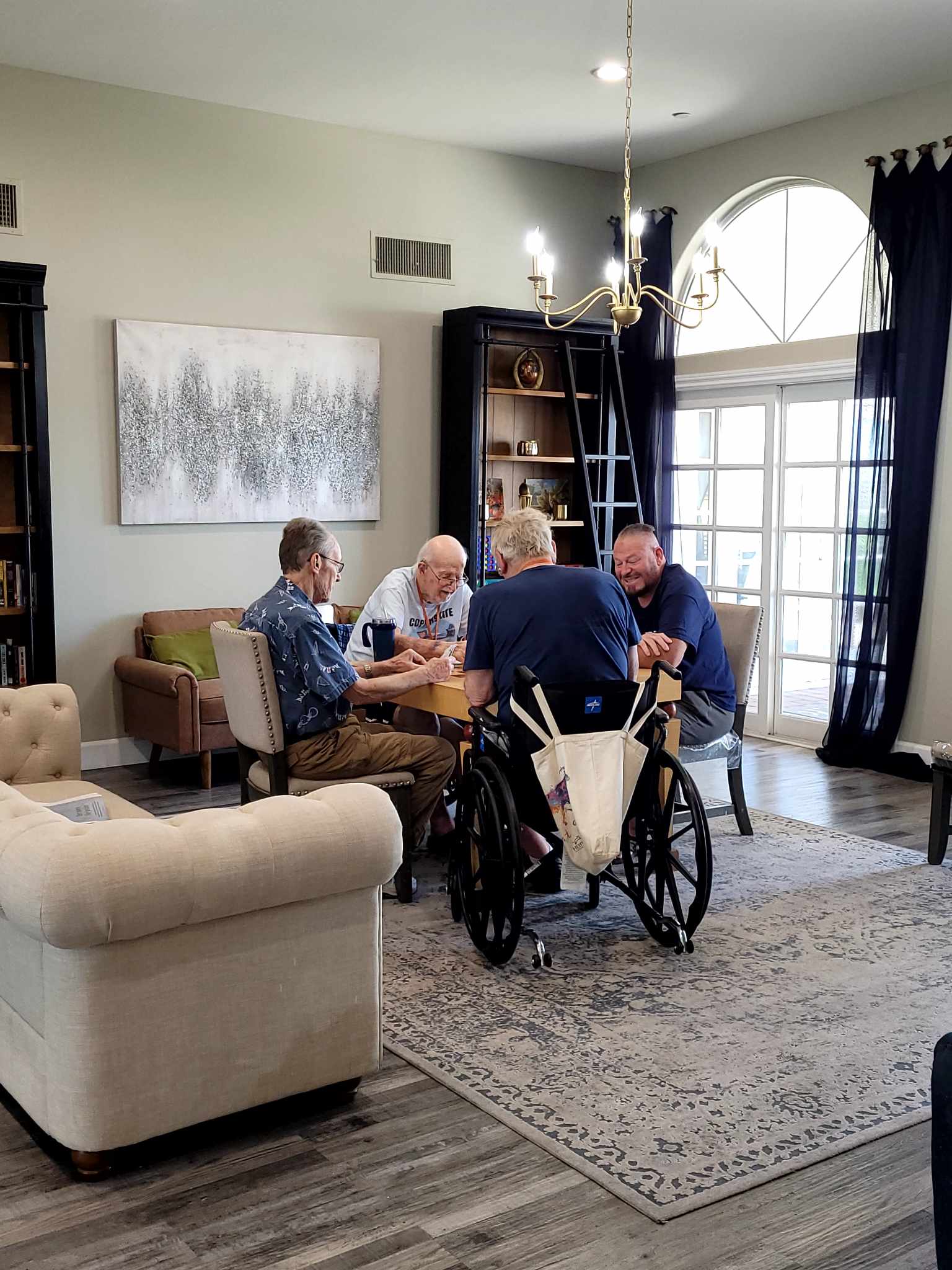 a group of people sitting around a living room table