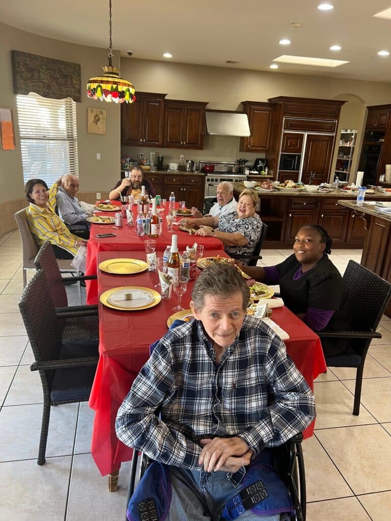 group of people sitting around a table eating food